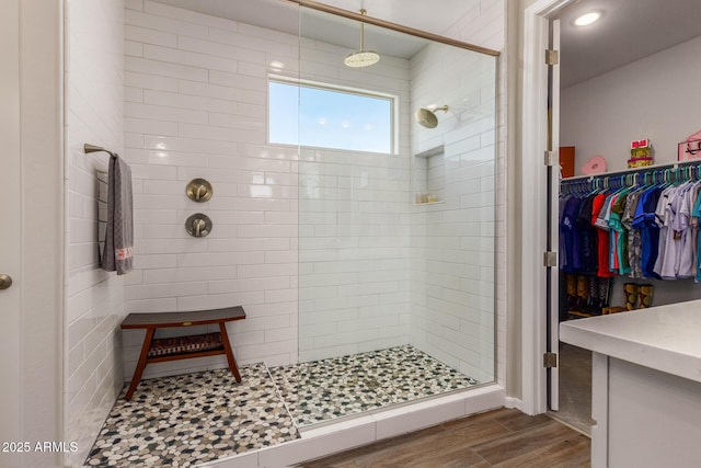 bathroom featuring hardwood / wood-style flooring and an enclosed shower