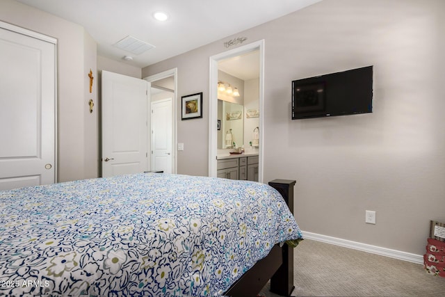 bedroom featuring carpet, ensuite bathroom, and a closet