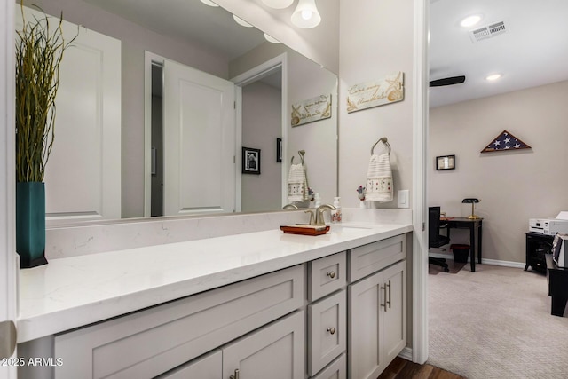 bathroom featuring ceiling fan and vanity