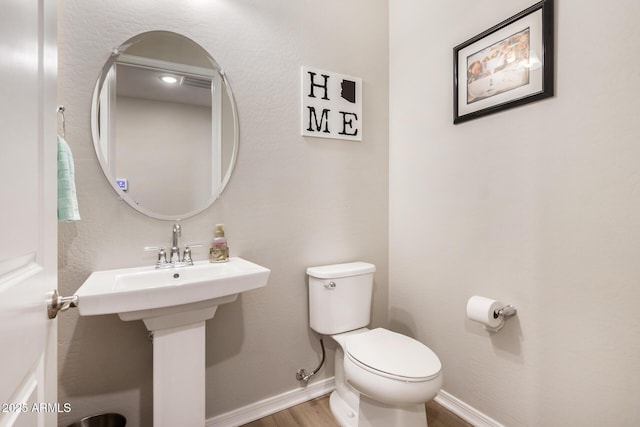 bathroom featuring toilet and hardwood / wood-style flooring