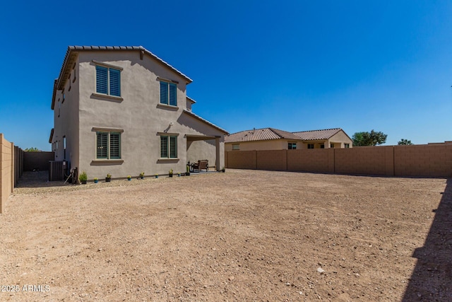 rear view of house with cooling unit