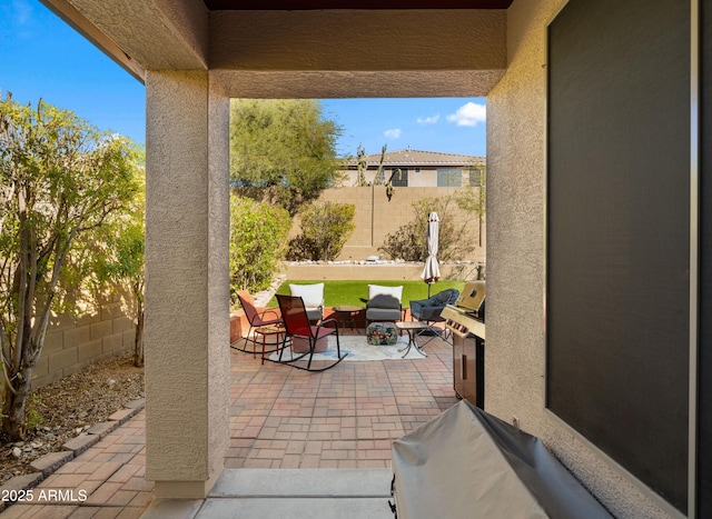 view of patio with outdoor lounge area, a fenced backyard, and grilling area