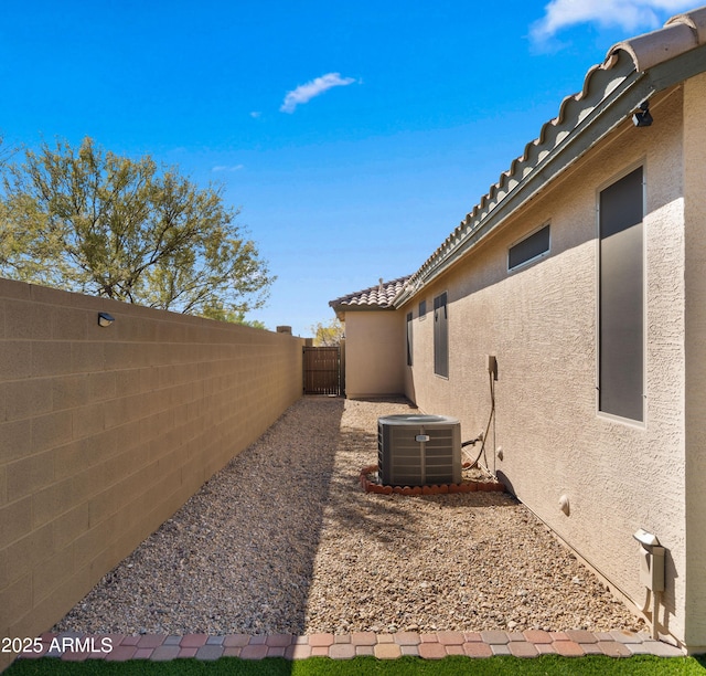 view of yard with central AC and a fenced backyard