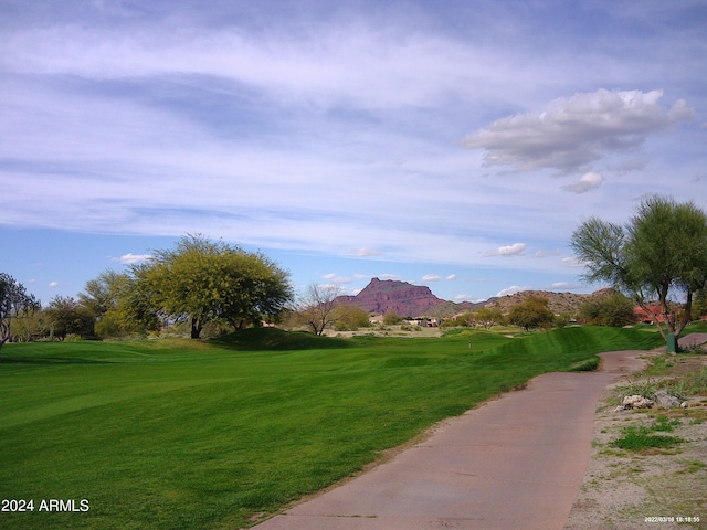 view of home's community featuring a mountain view and a yard