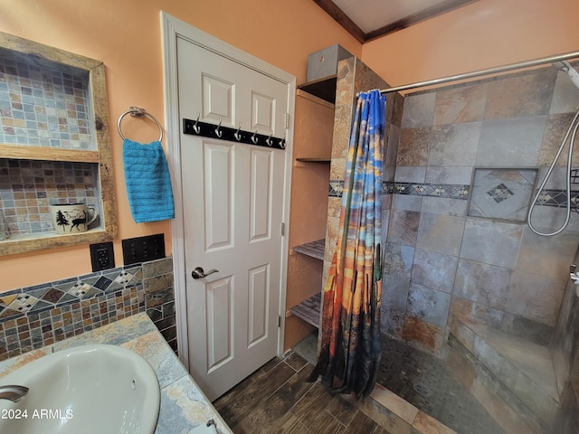 bathroom with sink, crown molding, a shower with curtain, and wood-type flooring