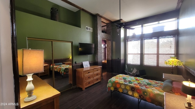 bedroom with a closet, hardwood / wood-style floors, and ceiling fan