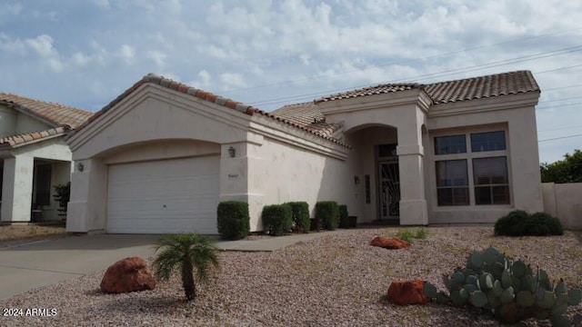 mediterranean / spanish-style home with a garage