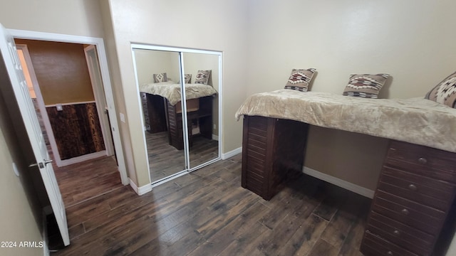 bedroom featuring dark hardwood / wood-style floors and a closet