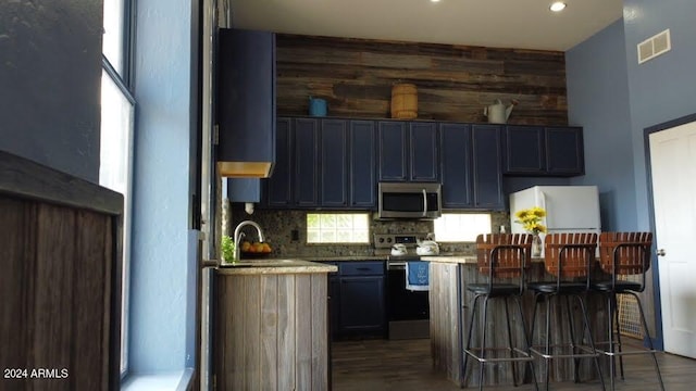 kitchen with appliances with stainless steel finishes, tasteful backsplash, and sink