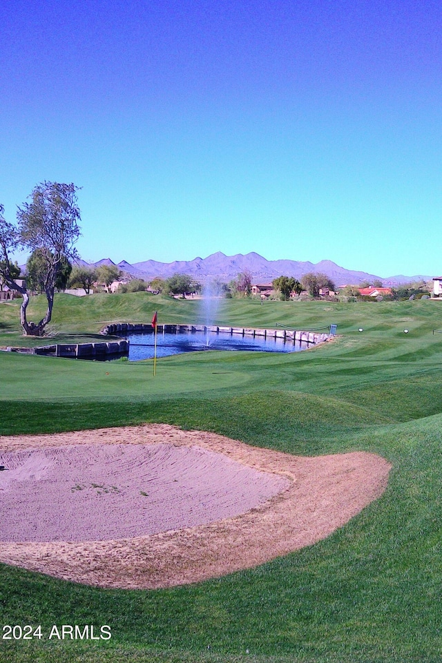 surrounding community featuring a water and mountain view and a yard