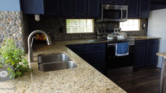 kitchen with tasteful backsplash, stainless steel appliances, sink, light stone countertops, and dark hardwood / wood-style floors