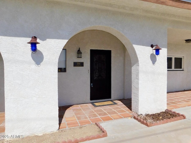 doorway to property with stucco siding