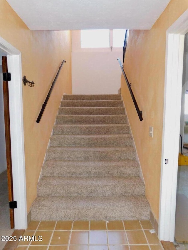 stairs with tile patterned flooring