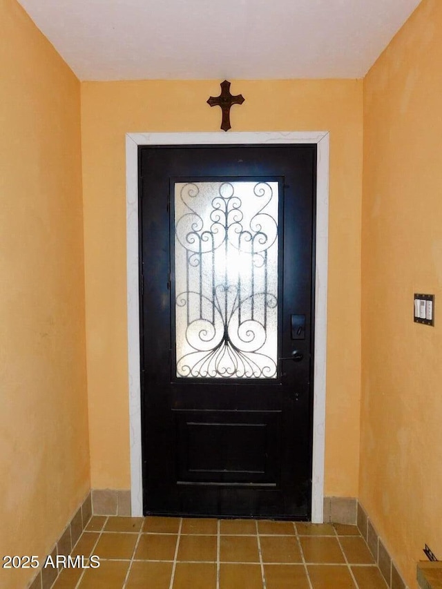 tiled entryway with baseboards