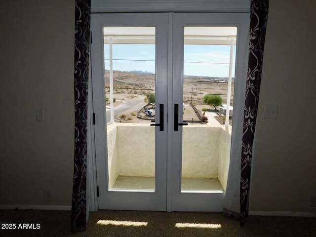 entryway with speckled floor and french doors