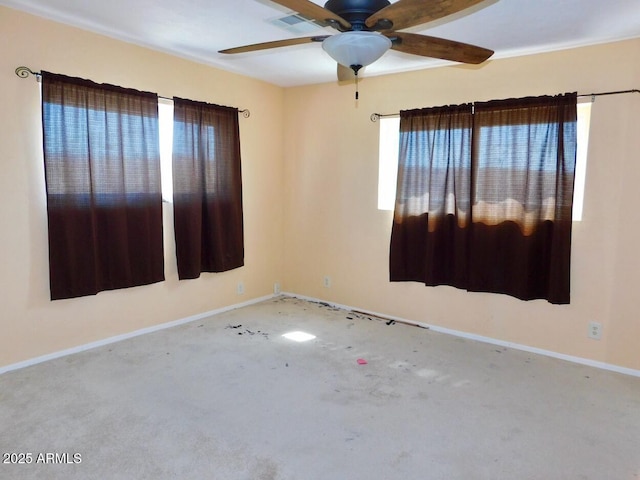 unfurnished room featuring carpet, ceiling fan, and baseboards