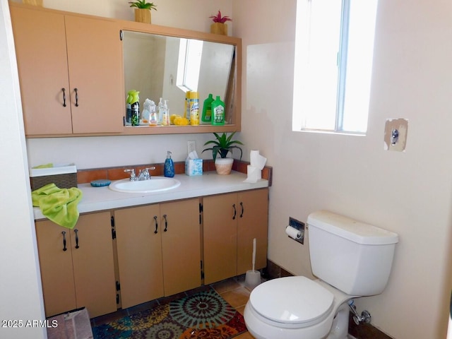 bathroom featuring vanity, toilet, and tile patterned floors