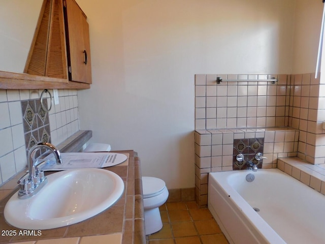 full bath featuring decorative backsplash, toilet, a bath, tile patterned flooring, and a sink