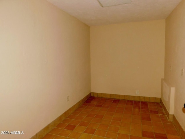 empty room with visible vents and baseboards