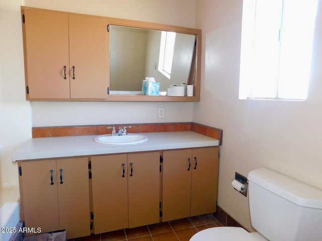 bathroom featuring toilet, tile patterned floors, and vanity