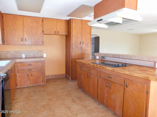 kitchen featuring light tile patterned floors, extractor fan, black electric cooktop, and brown cabinets