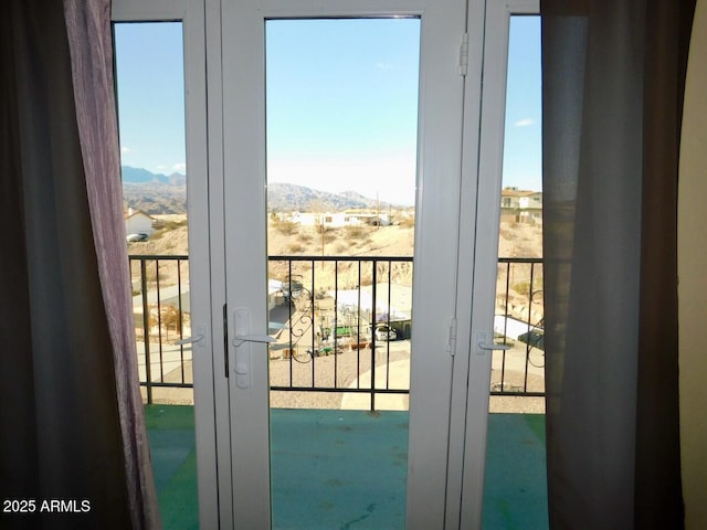 doorway to outside featuring french doors and a mountain view