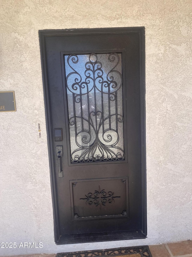 property entrance with stucco siding