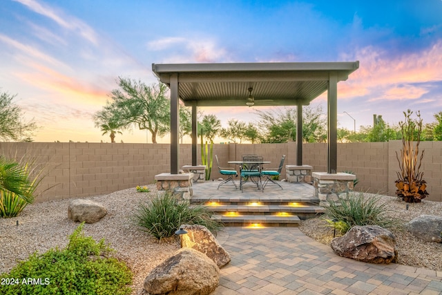 patio terrace at dusk featuring a deck