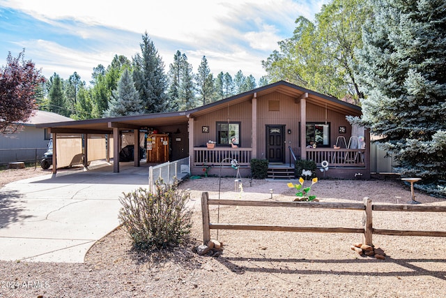 view of front of property with a carport and a porch