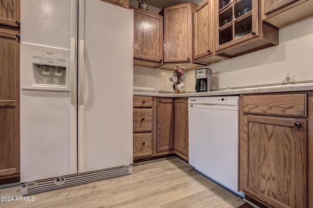 kitchen featuring white appliances and light hardwood / wood-style floors