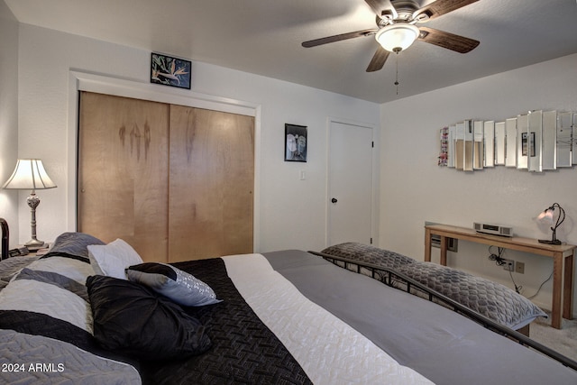 bedroom with ceiling fan and a closet