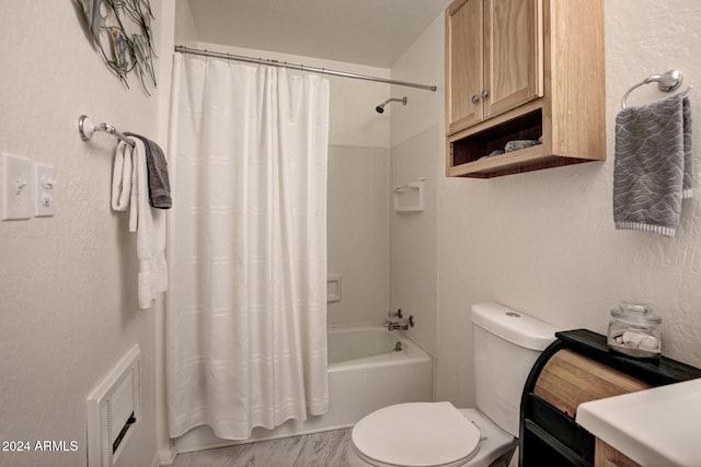 bathroom featuring toilet and shower / bath combo