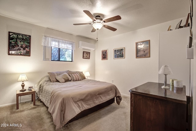 carpeted bedroom featuring ceiling fan and a wall mounted AC