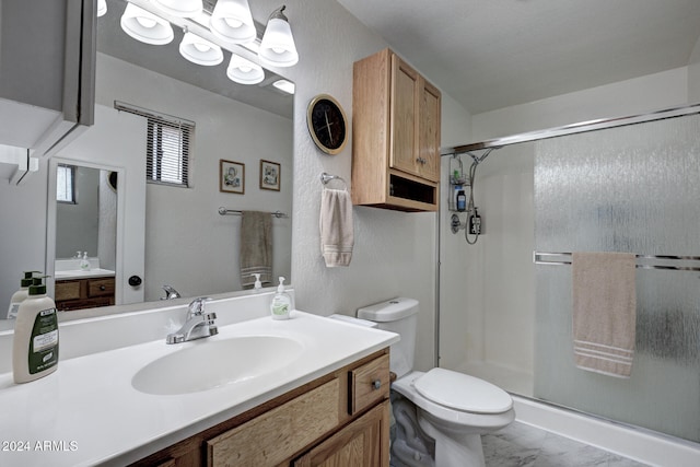 bathroom with walk in shower, vanity, and toilet