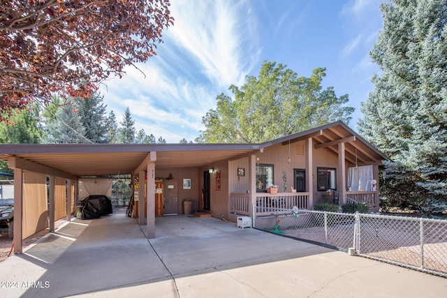 view of front of house with a carport and covered porch