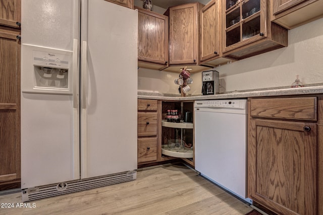 kitchen featuring white appliances and light wood-type flooring