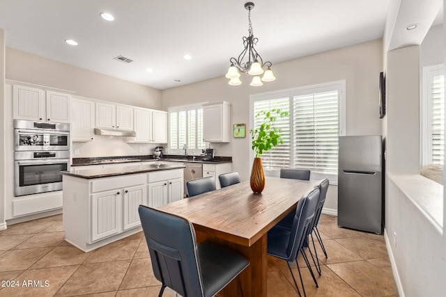 kitchen with a center island, appliances with stainless steel finishes, and white cabinetry