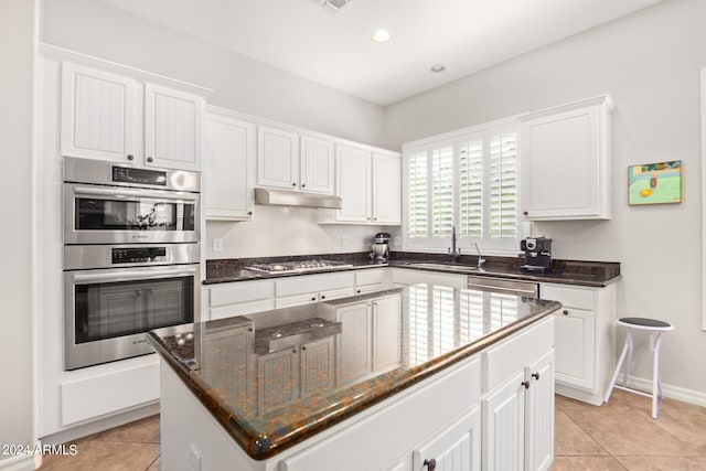 kitchen with white cabinets, a center island, and stainless steel appliances