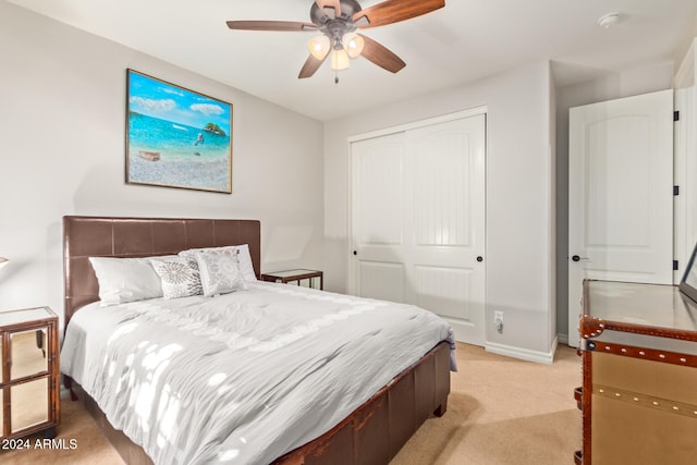 carpeted bedroom with a closet and ceiling fan