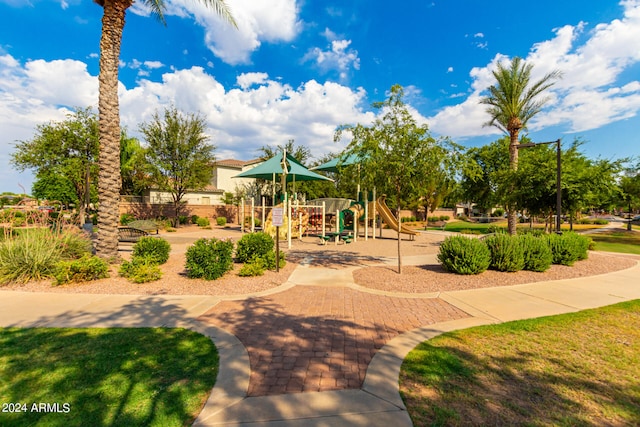 view of property's community with a lawn and a playground