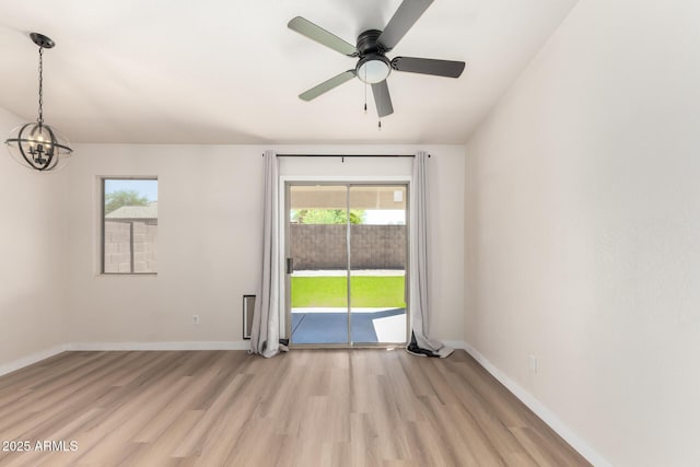 30212 N Sunray Dr, San Tan Valley, AZ 85143 - spare room featuring a chandelier, light wood-type flooring, baseboards, and a ceiling fan