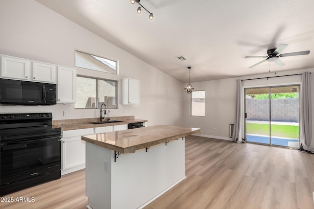 30212 N Sunray Dr, San Tan Valley, AZ 85143 - kitchen with black appliances, a sink, tile counters, lofted ceiling, and white cabinets