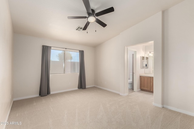 30212 N Sunray Dr, San Tan Valley, AZ 85143 - unfurnished bedroom with light colored carpet, baseboards, ensuite bathroom, ceiling fan, and vaulted ceiling