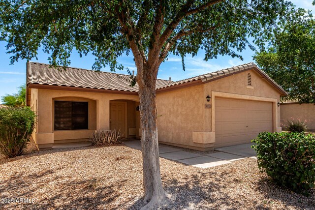 30212 N Sunray Dr, San Tan Valley, AZ 85143 - mediterranean / spanish-style house featuring an attached garage, a tiled roof, and stucco siding