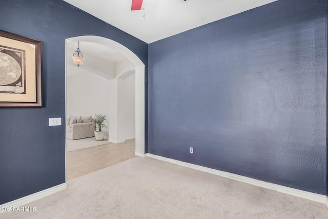 carpeted empty room with ceiling fan