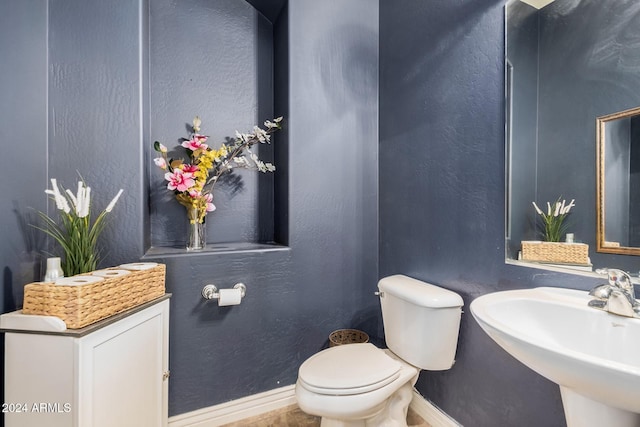 bathroom featuring toilet and sink