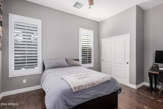 bedroom featuring ceiling fan, dark hardwood / wood-style flooring, and a closet