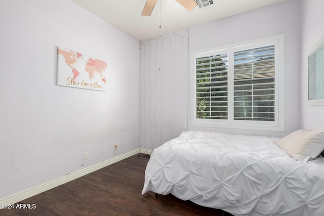 bedroom with dark hardwood / wood-style floors and ceiling fan