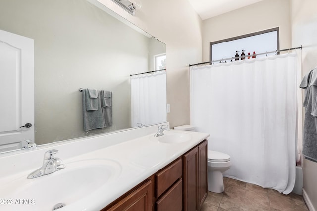 full bathroom featuring tile patterned floors, vanity, shower / bath combination with curtain, and toilet