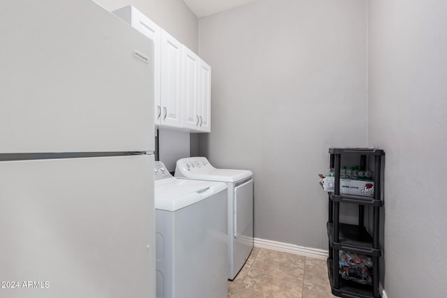 washroom with cabinets, light tile patterned floors, and separate washer and dryer